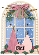 A festive Christmas window card design featuring two pink paper Christmas trees, silver bells with a pink bow, green pine branches, holly leaves, and a central pink ornament reading 'KERST' on a cream arched background.