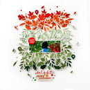 A layered scrapbook-style paper collage on a white background with red and orange autumn leaves at the top, green leaves surrounding a central photo insert, and the phrase 'delight in the little things' near the bottom.