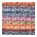 A close-up of a knitted fabric swatch showing horizontal stripes of variegated yarn in orange, pink, purple, blue, green, and brown.