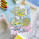 Colorful card with a lemon-themed design surrounded by stamping supplies on a light blue background.
