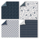 Four square fabric or paper swatches arranged in a 2x2 grid, each showing a different navy-and-white pattern with one corner peeled back to reveal the reverse side. The patterns include small white motifs on navy, blue floral vines on white, repeating scallop/扇 shapes on white, and vertical floral motifs on navy.