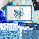 An open notebook or card set displayed on a light blue surface with nautical props. The central item shows a blue octopus illustration with a blue patterned border.