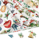 A stack of rolled Christmas-themed wrapping paper sheets with a festive watercolor print featuring red ornaments, green holly leaves, pine branches, snowflakes, candy canes, and gift boxes on a white background. Small decorative holiday props are arranged around the paper.