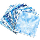 A fan of patterned paper sheets with winter-themed designs, including snowflakes, snowy trees, and blue-toned winter scenes, arranged on a white background.