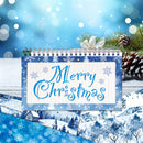 A spiral-bound Christmas-themed notebook or desk calendar with a blue and white winter border and the words “Merry Christmas” in blue script, styled with pine branches, a bow, and snowy landscape illustrations on a blue bokeh background.