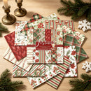 Collection of Christmas-themed scrapbooking paper sheets on a wooden surface with decorative elements.