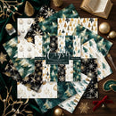 A flat-lay display of digital paper designs themed around Christmas and winter, featuring patterns of snowflakes, pine trees, ornaments, and gold glitter on dark teal, black, and cream backgrounds. The designs are arranged on a dark wooden surface with festive props including gold ornaments, a book, and a green velvet cloth.