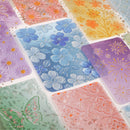 Collection of colorful floral and butterfly patterned tiles.