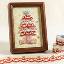 Decorative framed artwork with a tree design on a textured surface.