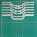 Set of plastic track pieces on a green cutting mat
