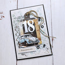 A handmade 18th birthday card featuring a vintage blue Volkswagen Beetle, a large white '18' cutout, twine, and Polish text 'Droga przed siebie' on a distressed white background, photographed on a white wood surface.
