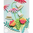 A close-up of a colorful floral craft or paper applique design featuring layered flowers and leaves in pink, orange, yellow, teal, and cream on a pale blue background.