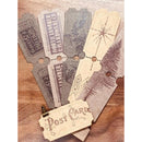 A set of vintage-style paper postcard designs fanned out on a wooden surface, featuring distressed text, starburst motifs, and tree illustrations in muted beige, gray, and brown tones.