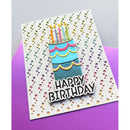 A handmade birthday card featuring a layered cake design with colorful candles and the words 'HAPPY BIRTHDAY' in raised letters, displayed on a purple sheet of cardstock against a light gray textured background.