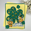 A handmade St. Patrick's Day greeting card featuring a yellow background with a large green shamrock filled with glitter and small shamrocks.