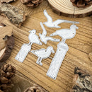A set of five metal bird silhouette cutouts, likely for scrapbooking, crafting, or laser engraving, displayed on a rustic wood slice background with pinecones.