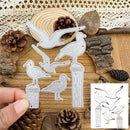 A hand holds a metal die-cut craft set featuring five seagull and bird designs standing on posts, shown over a rustic wood background with pinecones, bark, and lace. A small inset in the lower right shows the matching printed design sheet.