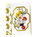 A handmade greeting card with a white background, gold foil accents, and a central octagonal label featuring colorful watercolor-style flowers and butterflies. The label reads 'Miss you SO VERY MUCH' in elegant script and serif text.