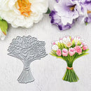 A floral bouquet-shaped metal craft die shown next to a colorful printed bouquet illustration on a textured white surface, with decorative flowers in the background.