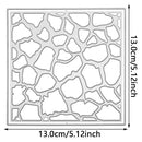 A square stencil or template with an irregular stone-pattern cutout design, shown with dimension arrows and labels indicating 13.0 cm / 5.