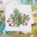 A square white card featuring a hand-drawn illustration of green pine branches with red berries, set against a soft background of white, blue, and yellow flowers.