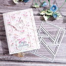 A handmade layered card with a butterfly and floral design next to a silver geometric die-cutting or embossing template, displayed on a rustic wooden surface with decorative flowers.