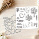 A sheet of clear stamps with black-and-white floral and quote designs displayed beside matching metal stamp dies on a light wood surface, styled with dried flowers and white blossoms.