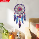 Colorful dreamcatcher hanging on a wall in a room with a couch and plant.