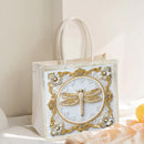 Decorative tote bag with a beaded dragonfly design on a neutral background