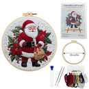 Embroidery DIY art kit with Santa Claus design, hoop, threads, and tools on a white background.