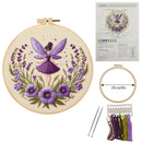 Embroidery kit with hoop, fabric, threads, and pattern guide featuring a fairy and floral design.