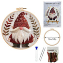 Embroidery DIY art kit shown with a completed gnomes-themed embroidery piece in a wooden hoop, product packaging, a second empty hoop with a 15cm size marker, a needle, tweezers, and a package of multicolor embroidery floss on a white background.