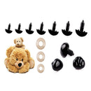 A set of black plastic teddy bear-shaped adhesive belly buttons with three beige circular skin protectors and a small plush teddy bear toy, displayed on a clean white background.