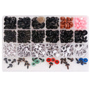 A clear plastic organizer tray filled with assorted small hardware pieces, including black screws, white and gray eye fasteners, pink plastic pieces, green and red eye pieces, and blue eye pieces, photographed on a white background.