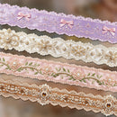 Set of decorative ribbons with floral and bow designs on a blurred background