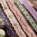 Collection of decorative ribbons with floral patterns on a wooden surface.