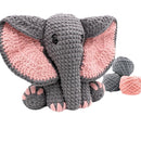 Crocheted elephant toy with pink inner ears on a white background