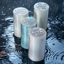 Four cylindrical products labeled 'Misty Reverie' on a reflective water surface with raindrops.