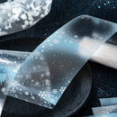 Clear plastic sheet with snowflake patterns on a dark background