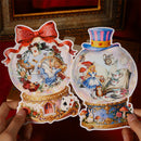 Two decorative plates with Alice in Wonderland design held by hands against a blurred background.