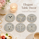 Six round pearl-embellished table coasters with animal motifs (owl, bird, bee, cat, elephant, butterfly) arranged on a marble surface with lifestyle props including a candle, flowers, and a cup of coffee. Text reads 'Elegant Table Decor' and '6 unique pearl coaster designs'.