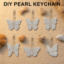 Six pearl-embellished butterfly keychains arranged on a textured beige surface with small decorative props. The text 'DIY PEARL KEYCHAIN' appears at the top.