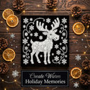 A square black holiday art print featuring a white reindeer and snowflakes, styled on a dark wood surface with pinecones, dried orange slices, fairy lights, and a banner reading 'Create Warm Holiday Memories'.