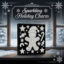 A square black canvas or box featuring a white glittery gingerbread man and holiday star pattern, displayed on a windowsill with snowy outdoor scenery visible behind it. Decorative snowflakes and the text 'Sparkling Holiday Charm' appear in the scene.