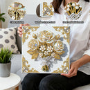 Person holding a decorative painting with floral design, pearl embellishments, and wooden frame.