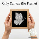 Hands holding a square canvas print featuring a sparkling butterfly design made of clear rhinestones on a black background, with a light wood frame. Text at the top reads 'Only Canvas (No Frame)' and a circular inset shows pearl details.