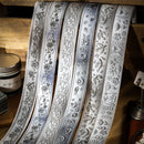 Decorative ribbons with floral patterns on a wooden surface