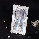 Decorative paper cutout of a ribbon with stars on a black background
