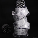 Stack of silver washi tape rolls with decorative patterns on a black background