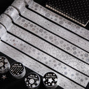 Decorative paper strips with patterns and a set of stamps on a black background